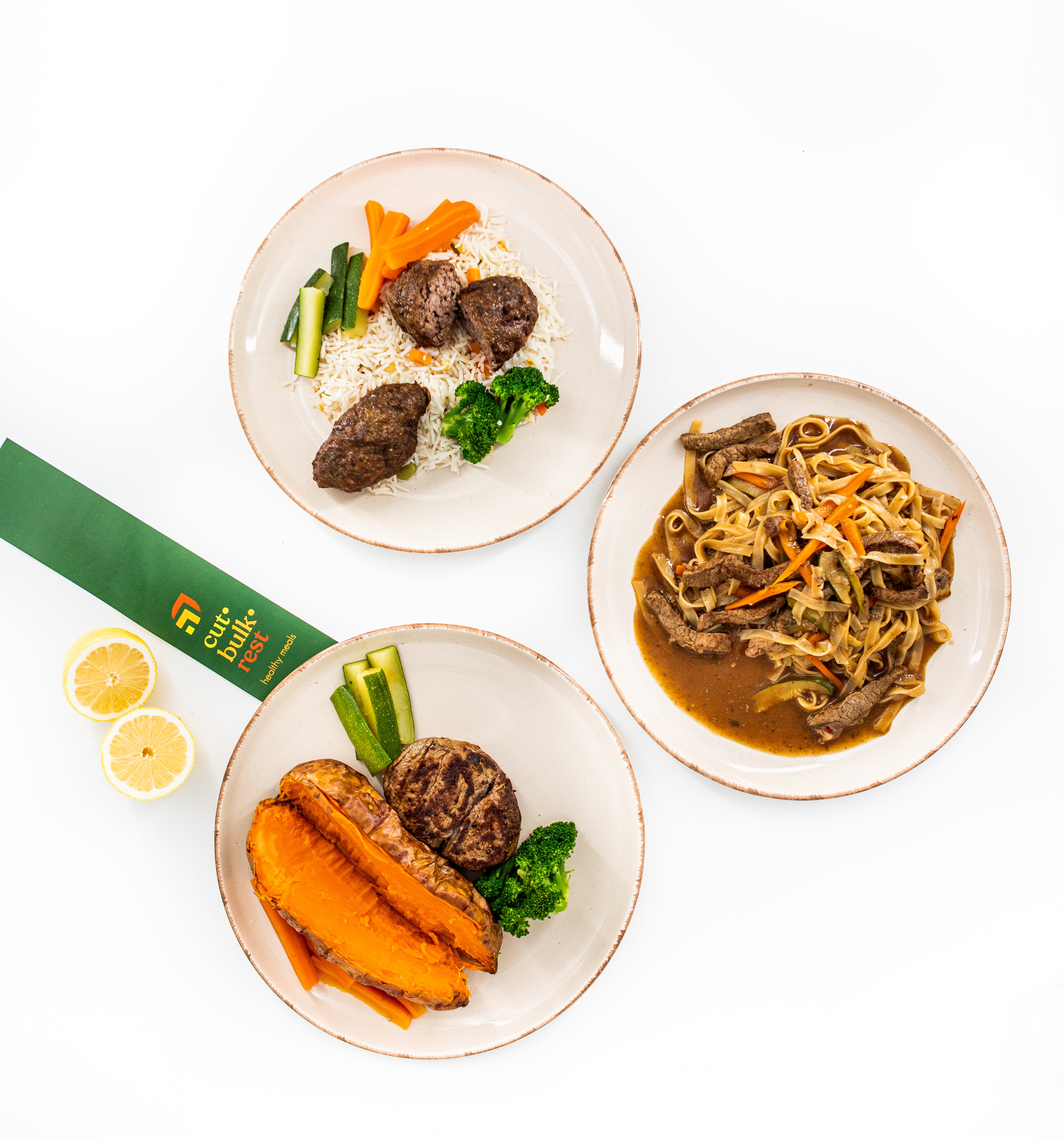Three plates of food including noodles, vegetables, and sweet potatoes on a white background with a green banner.