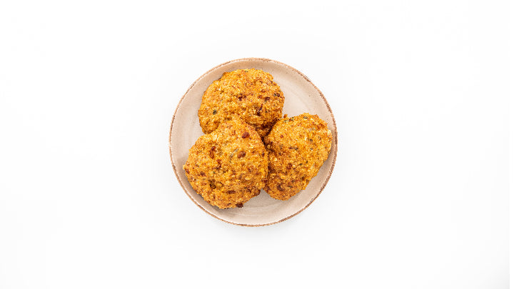 Three cookies on a white plate with a white background